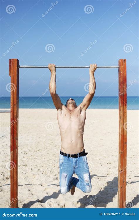 A Male Athlete With A Naked Torso Is Training On A Horizontal Bar Stock Image Image Of Power