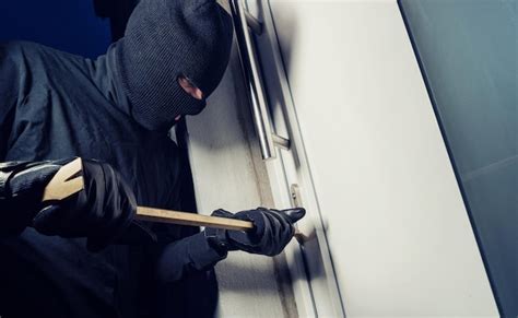 Premium Photo Burglar Wearing Black Clothes And Breaking In A House