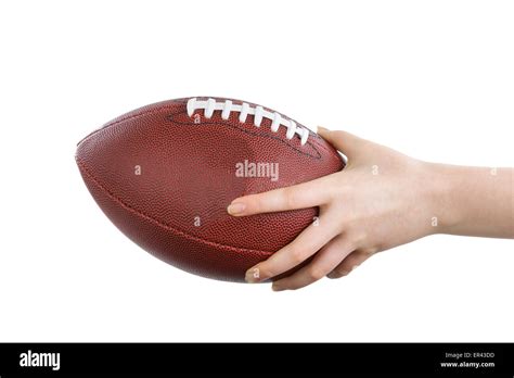 Female Hand Holding American Football On Isolated White Background