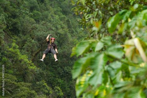 Thrill-seekers zip through the lush canopy of an Ecuadorian rainforest ...