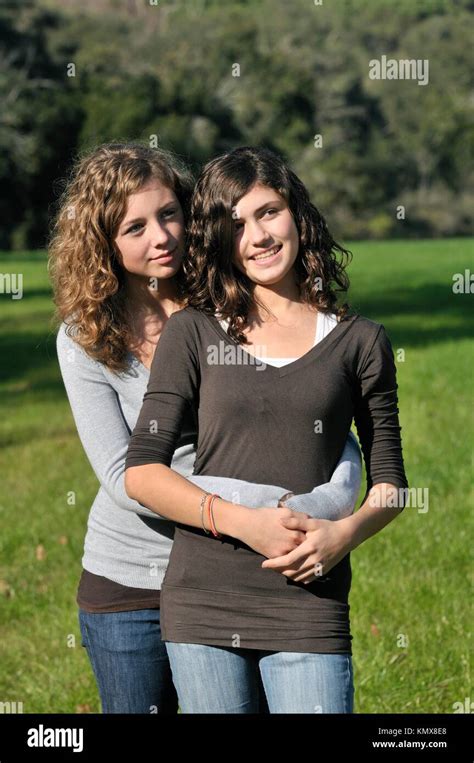 Two Teenage Girls Hugging And Smiling Stock Photo Alamy