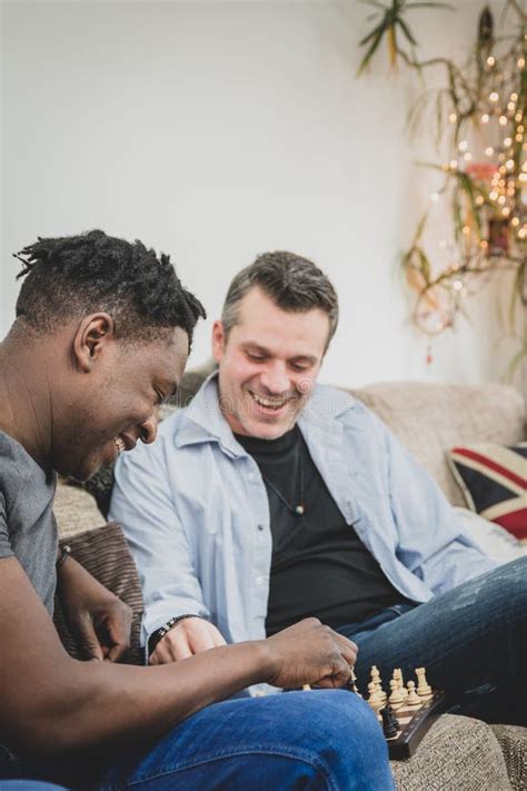 A Gay Couple Enjoying Time Indoors At Home Playing Chess Stock Photo Image Of Love Home