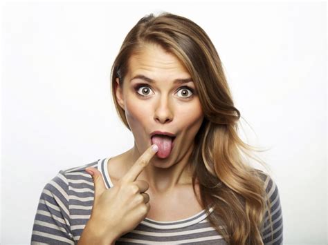 A Young Women Making A Curious Face With Her Tongue Out And Hand