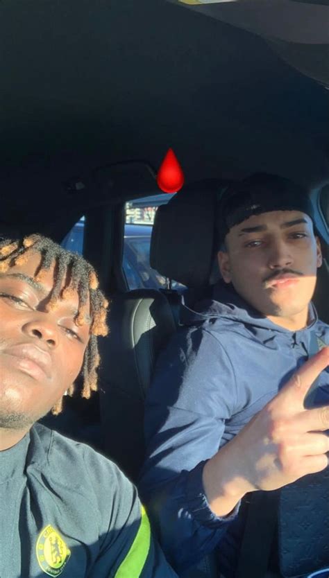 Two Men Sitting In The Back Seat Of A Car One With Dreadlocks