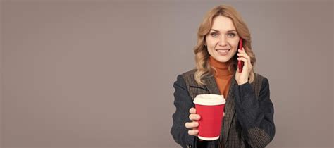 Premium Photo Happy Woman Talk On Mobile Phone Giving Hot Cup Grey