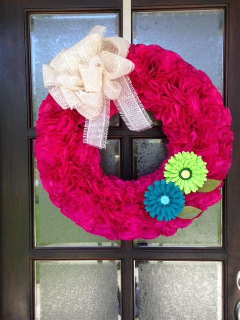 A Pink Wreath With Flowers On The Front Door