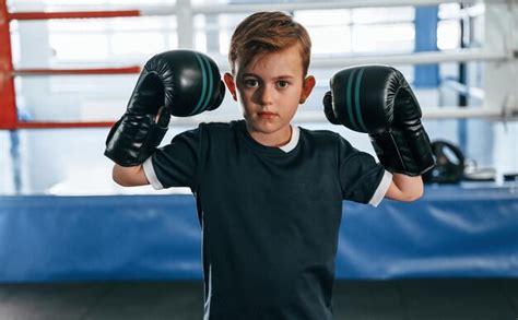 Premium Photo | Boy is practicing boxing in the gym with glowes on hands