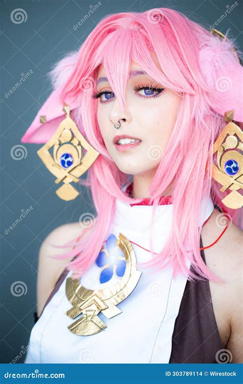 Female Cosplayer in a Pink Anime Costume Wearing Pink Hair Stock Photo - Image of anime, raises ...