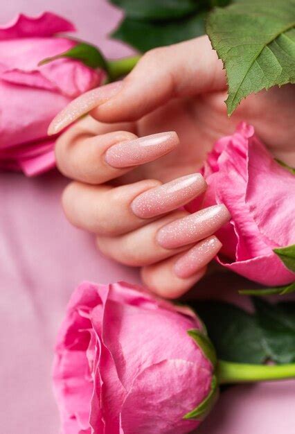 Premium Photo Female Hands With Pink Nail Design Hold Pink Roses