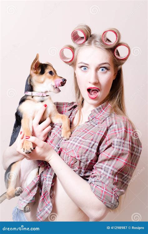 Closeup On Surprised Pinup Blond Young Beautiful Woman Holding A Dog In