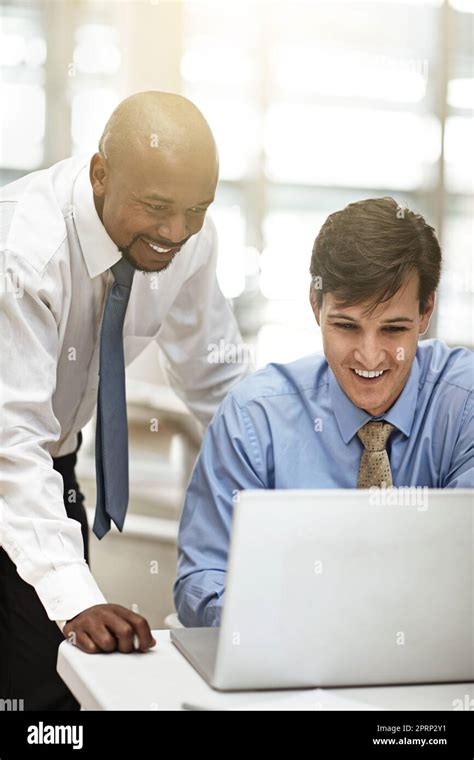 Hes Impressed Two Businessmen Discussing Work In The Office Stock