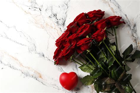 Premium Photo Bouquet Of Red Roses On A Textured Background Love Confession Valentines Day