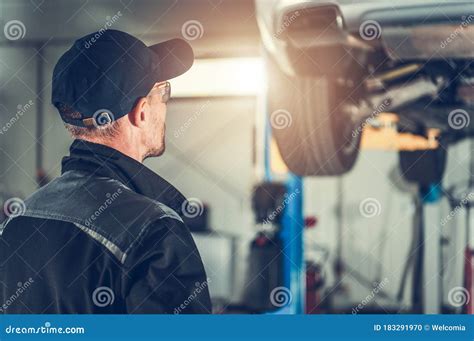 Mechanic Repairing Car At Service Station Stock Photo Image Of