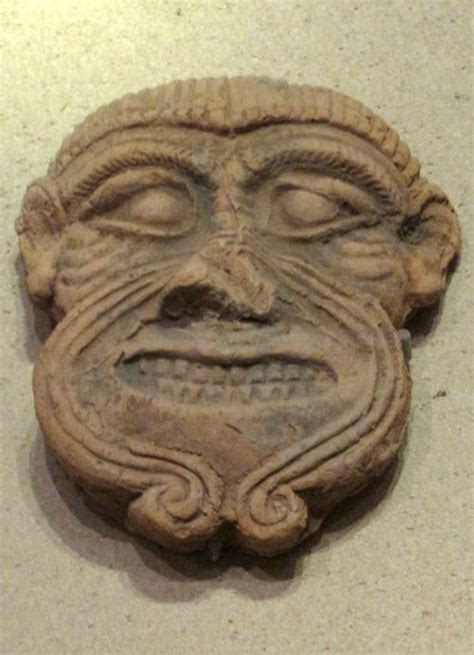 an ancient mask is displayed on the wall