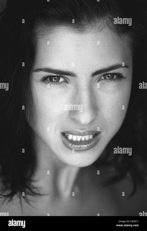 Female With Brunette Hair Looking To Camera Mouth Open Showing Teeth Stock Photo Alamy