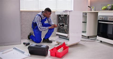 African Repairman Repairing Dishwasher Appliance Stock Image Image Of