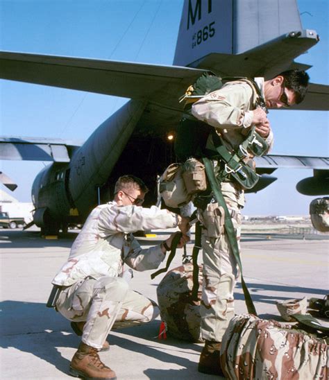 SENIOR AIRMAN Justin Ivie Left Adjusts The Parachute Harness Of