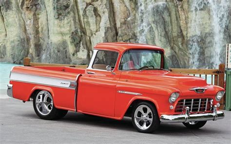 Chevrolet Truck Parked In Front Of A Rock Wall