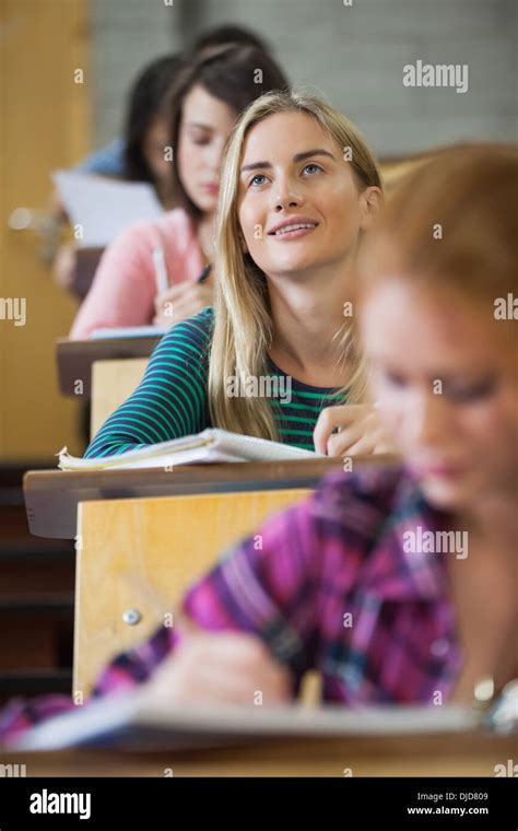 Pretty Blonde Student Thinking In A Lecture Hall Stock Photo Alamy