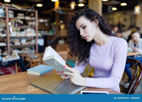 Young Pretty Girl Reading Book in Coffee Shop Stock Image - Image of ...