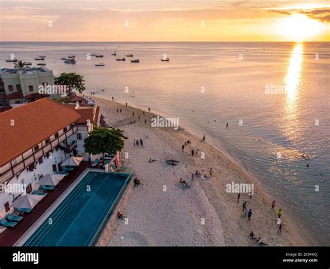 People Are walking on Sunset Beach. Zanzibar Aerial Shot of Stone Town ...