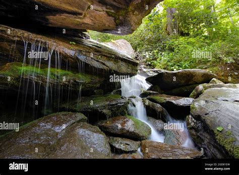 Silky Water Flowing Over Rocks And Moss At Otter Falls Trail In Seven