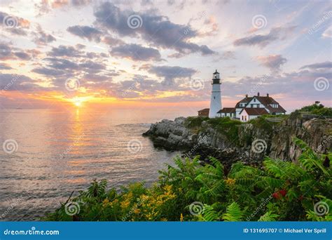 Sunrise at Portland Head Lighthouse with Flowers in the Foreground Stock Image - Image of ...