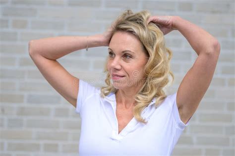Close Up Portrait Of An Attractive Blonde Woman Stroking Her Hair Stock Photo Image Of Blond