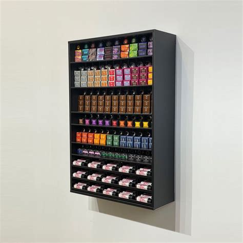 A Wall Mounted Display Case Filled With Lots Of Different Colored