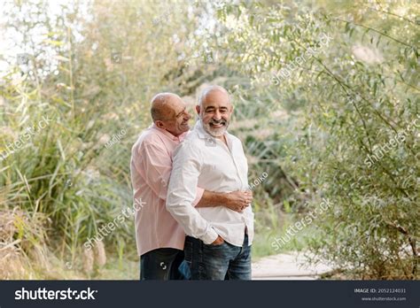 Affectionate Gay Couple Hugging Smiling While Stock Photo 2052124031 Shutterstock