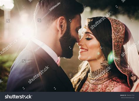 Handsome Bearded Indian Groom Kisses Bride Stock Photo 764321713