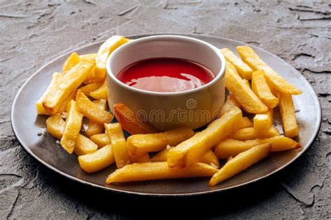 French Fries With Tomato Sauce Crispy Potato Chips On A Black Table