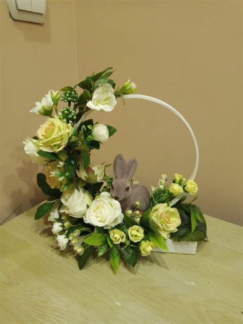 A Basket With Flowers And A Bunny Sitting In It