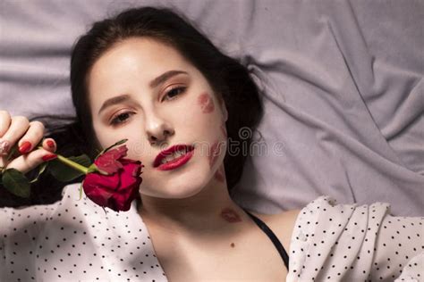 Brunette Woman With Kisses Lipstick Marks On Her Face And Neck With Red Rose Girlfriend Date