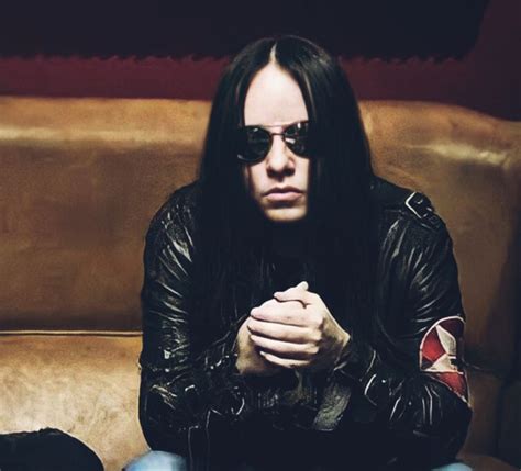 A Man With Long Hair And Sunglasses Sitting On A Couch