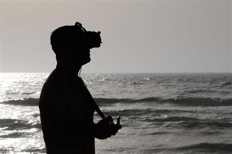 Premium Photo | Person flying a drone on the beach