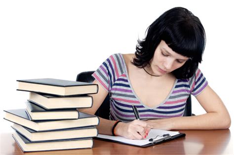 Красавица с длинными волосами сидит за столом с книгой и пишет ...