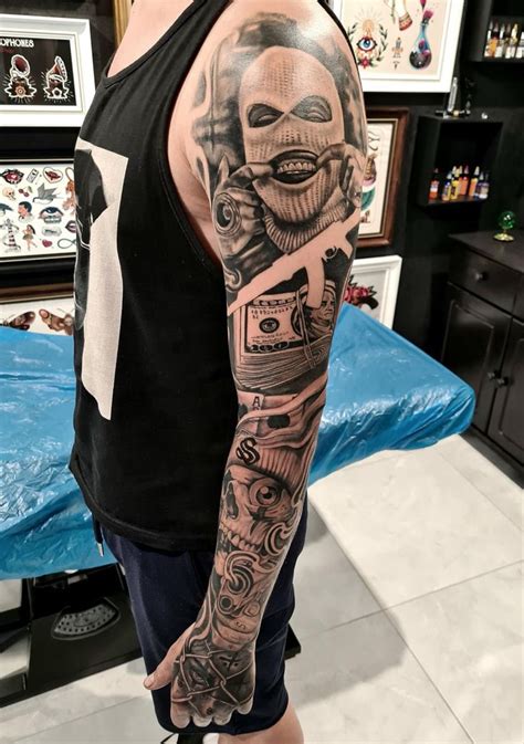 A Man With A Tattoo On His Arm