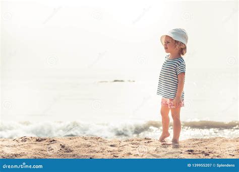 Child Kid Girl On Beach Looking Into The Distance Searching For