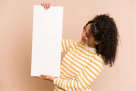 Premium Photo Young African American Woman Holding A Banner Isolated