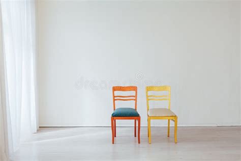 Two Vintage Chairs In The Interior Of An Empty White Room Stock Photo