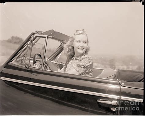 Blonde Woman Driving A Convertible by Bettmann