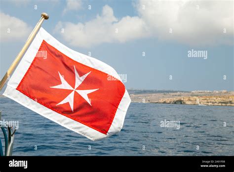 The merchant flag of Malta with white Maltese cross on a red background ...