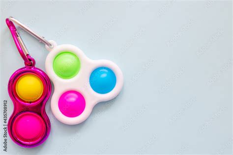 colorful antistress sensory toy fidget push simple dimple on blue background Stock Photo | Adobe ...