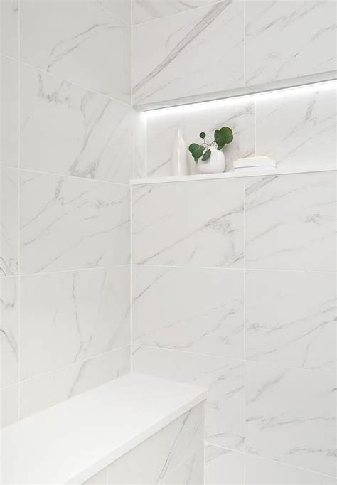 Shower Features A Marble Niche With Custom Lighting Over Stacked Marble