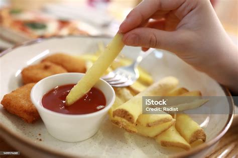 Person Dipping French Fries In Ketchup Stock Photo Download Image Now