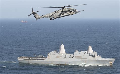 A U S Marine Corps Ch E Super Stallion Helicopter Flies Above Uss