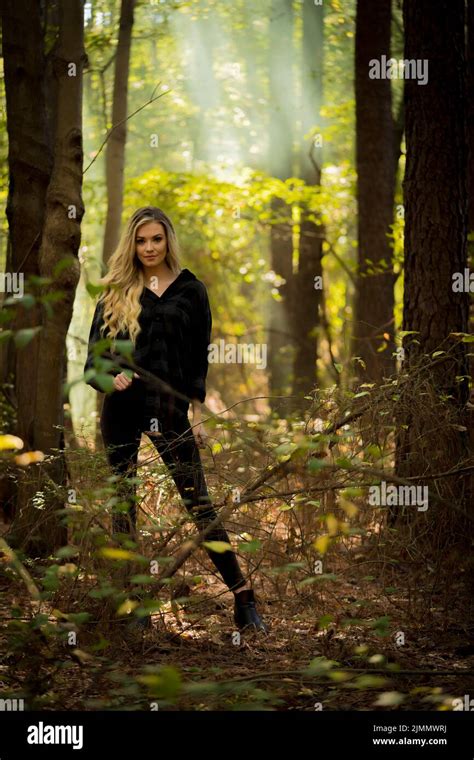 A Lovely Blonde Model Poses Outdoors In A Forrest Environment Stock Photo Alamy