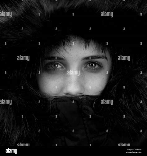 Blue eyes in a fur hood Stock Photo - Alamy