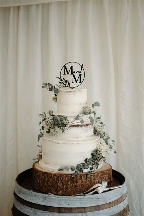White Semi Naked Wedding Cake With Greenery